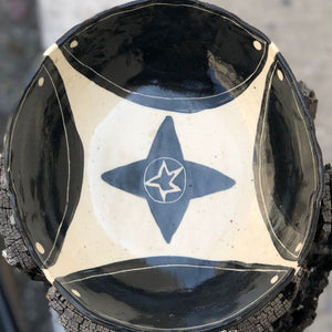 Hand-painted ceramic bowl with a native black star